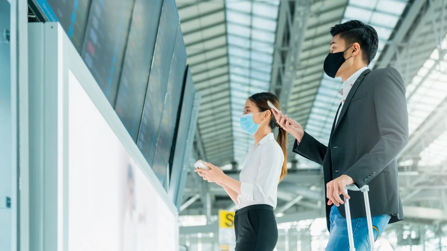 Travelers checking flight information before a Nepal journey