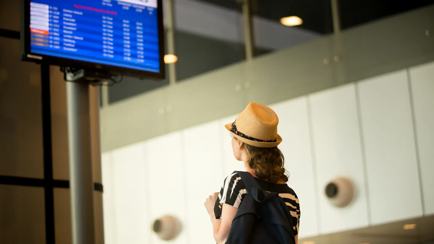 Traveler checking airport information during a digitally planned trip