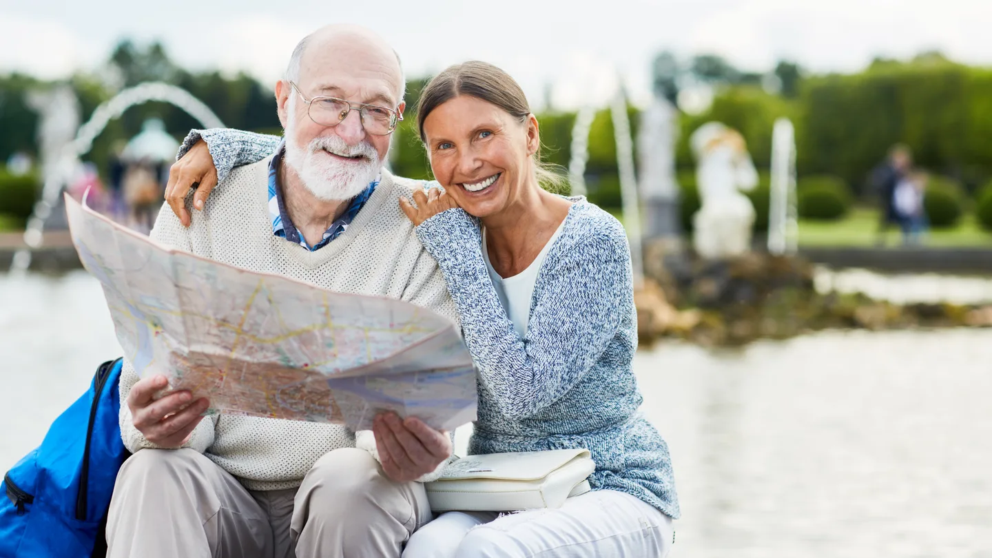 Senior travelers using a map before a major pilgrimage journey