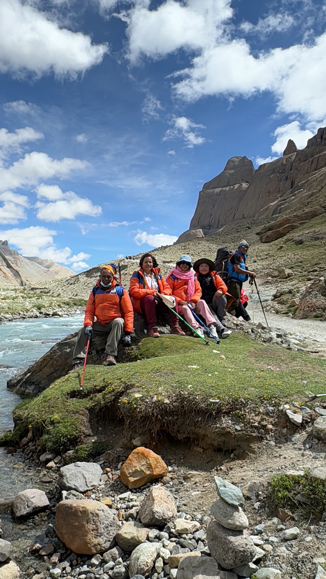 Kailash pilgrims resting beside a mountain river